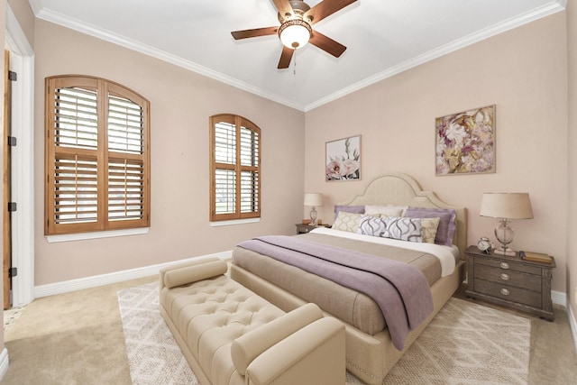 carpeted bedroom featuring a ceiling fan, crown molding, and baseboards