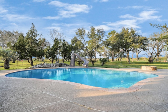 outdoor pool featuring a yard and a water slide