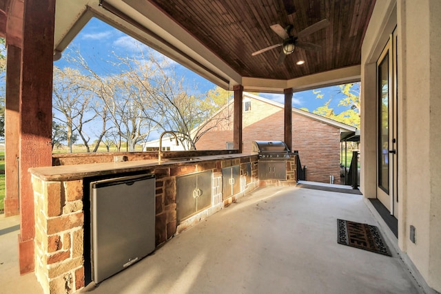 view of patio / terrace with an outdoor kitchen, a grill, ceiling fan, and a sink