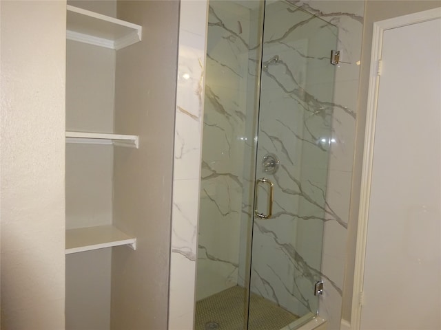 full bath featuring a marble finish shower