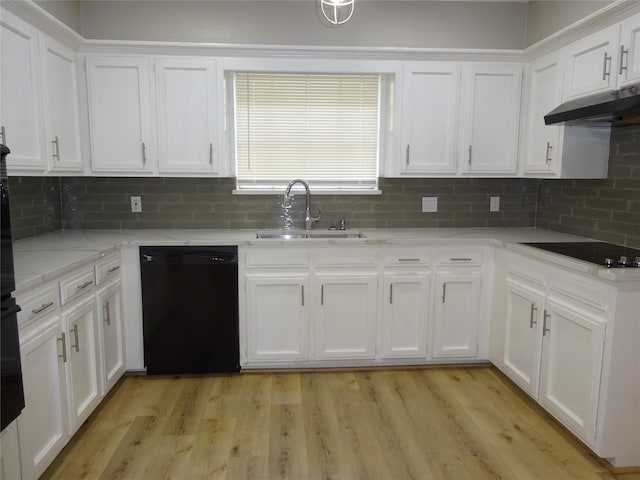 kitchen featuring black appliances, light wood-style flooring, a sink, light stone counters, and white cabinets