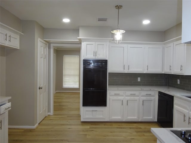 kitchen featuring visible vents, black appliances, white cabinets, and light wood-style flooring