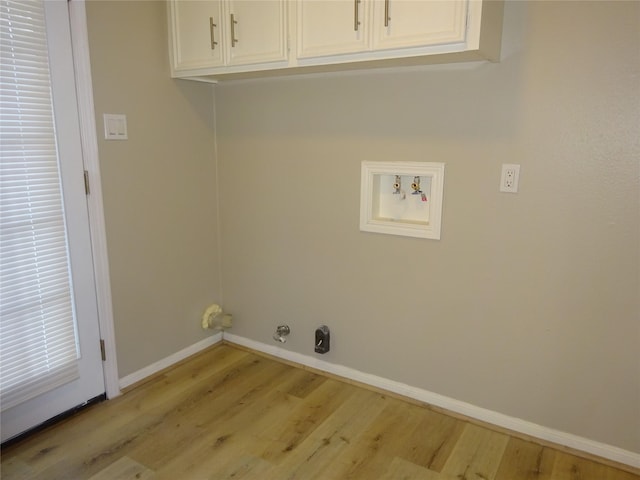 laundry room featuring cabinet space, baseboards, washer hookup, and light wood-style flooring