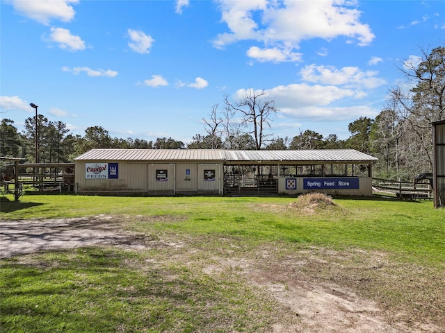 exterior space featuring metal roof and an outdoor structure