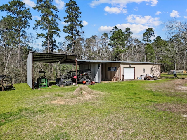 view of pole building with a yard and driveway