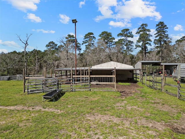 view of yard featuring an exterior structure, an outbuilding, and a carport