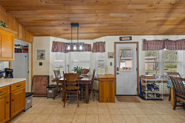 dining room with wooden ceiling and light tile patterned floors