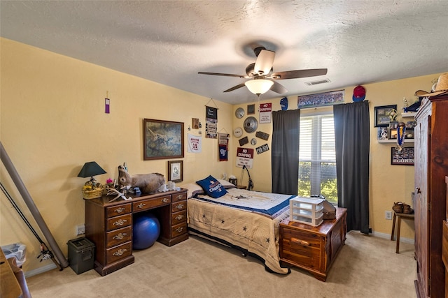 bedroom featuring visible vents, baseboards, light carpet, a textured ceiling, and a ceiling fan