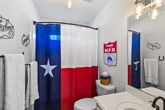 bathroom with visible vents, toilet, vanity, and a shower with curtain