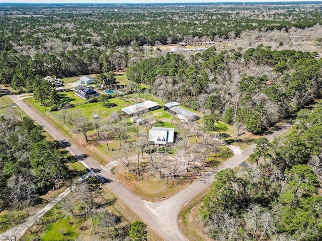 drone / aerial view featuring a forest view