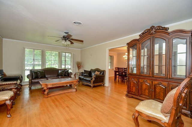 living room featuring visible vents, light wood-style flooring, and crown molding