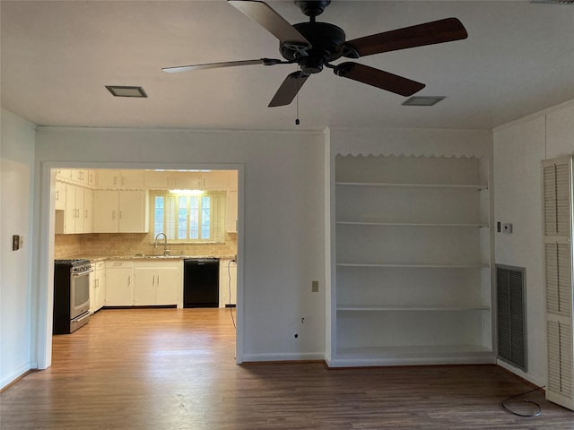 interior space featuring gas stove, visible vents, a sink, black dishwasher, and light wood-type flooring