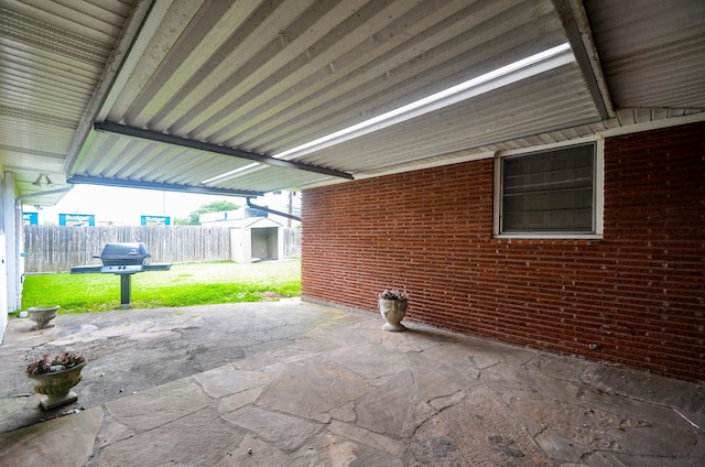 view of patio / terrace featuring a shed, an outdoor structure, and fence