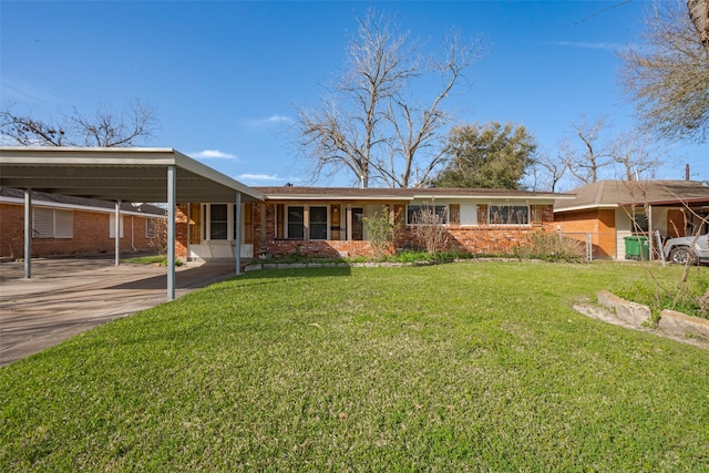 single story home with an attached carport, a front yard, brick siding, and driveway