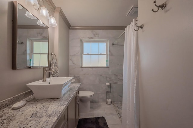 bathroom with toilet, plenty of natural light, and a tile shower