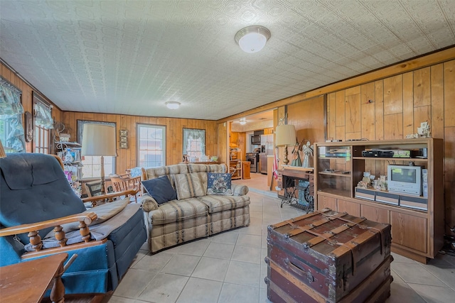 living room with light tile patterned flooring and wood walls