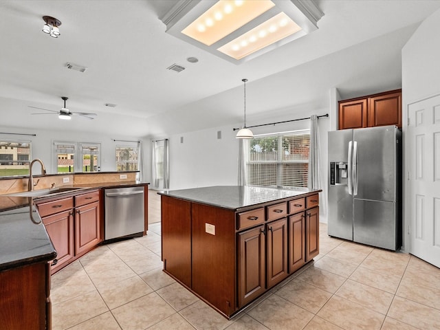 kitchen featuring light tile patterned floors, stainless steel appliances, dark countertops, and visible vents