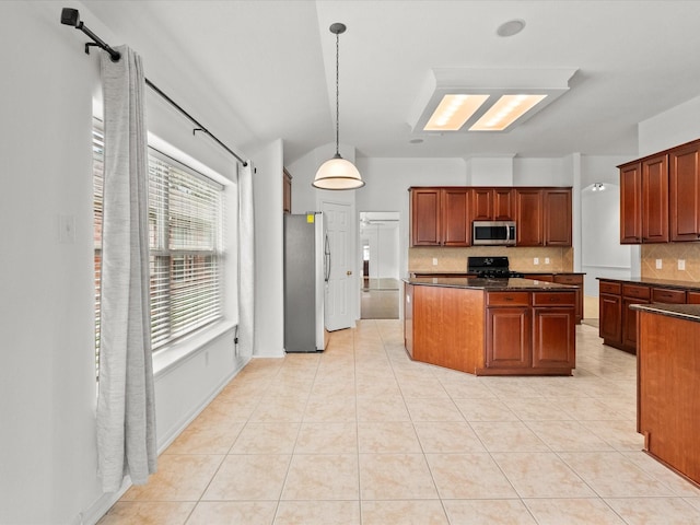 kitchen with decorative backsplash, dark countertops, light tile patterned flooring, and stainless steel appliances