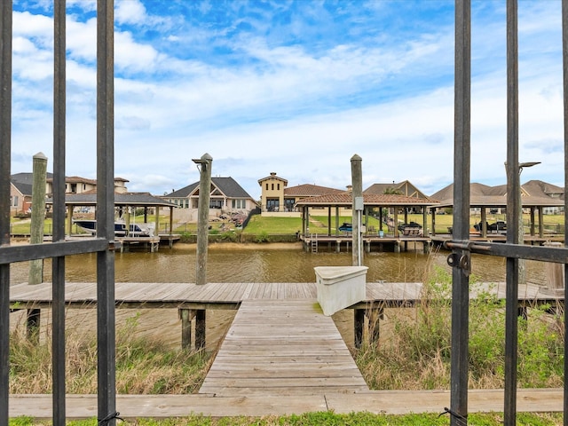 dock area with a water view and boat lift