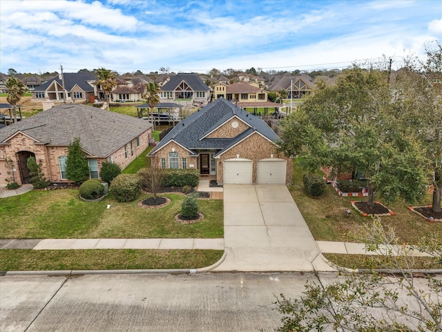 traditional home featuring brick siding, a residential view, driveway, and a front yard
