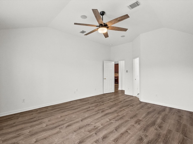 spare room featuring visible vents, wood finished floors, ceiling fan, and vaulted ceiling