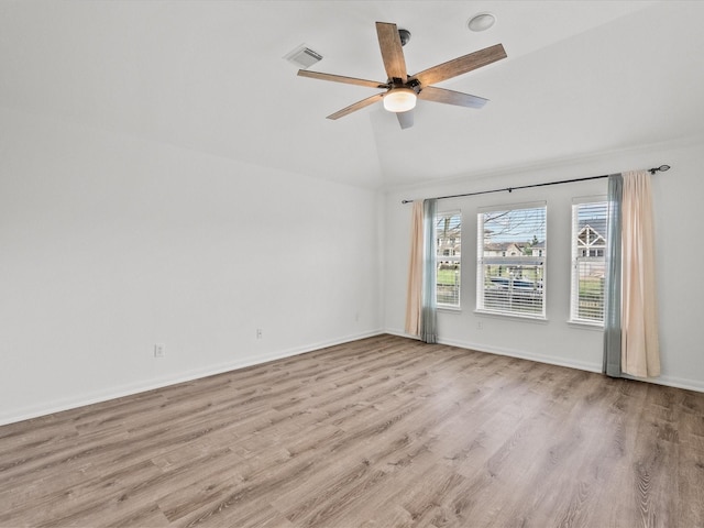 unfurnished room featuring wood finished floors, baseboards, visible vents, ceiling fan, and vaulted ceiling