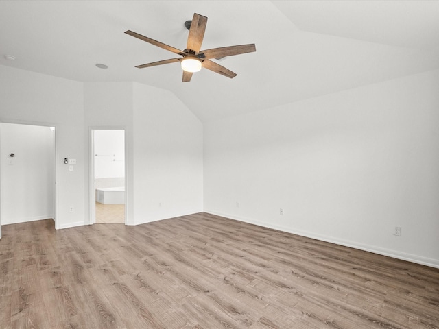 interior space featuring vaulted ceiling, wood finished floors, baseboards, and ceiling fan