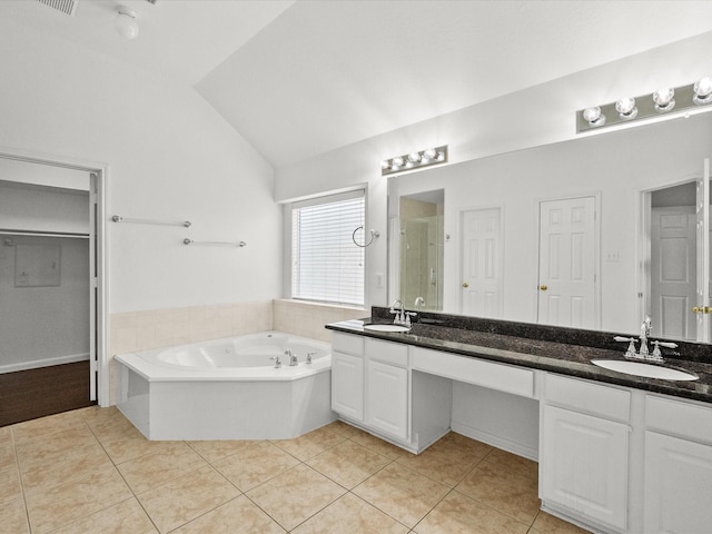 full bath with tile patterned flooring, a stall shower, and a sink