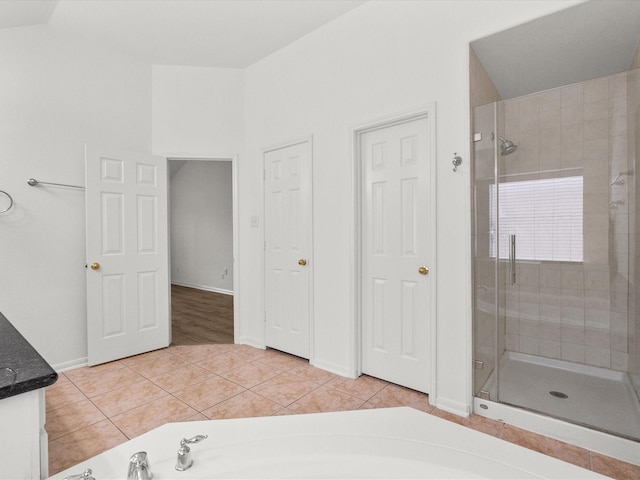 full bath with tile patterned floors, a shower stall, a bath, and baseboards