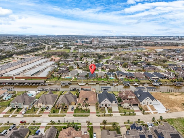 drone / aerial view with a residential view and a water view