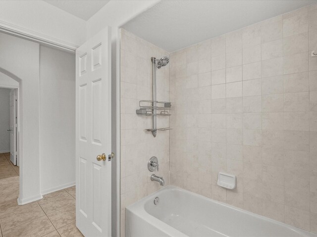 bathroom with tile patterned flooring and washtub / shower combination