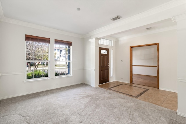 entrance foyer with tile patterned floors, visible vents, carpet floors, and ornamental molding