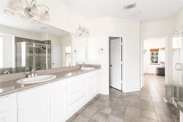 full bathroom featuring a sink, visible vents, a stall shower, and double vanity