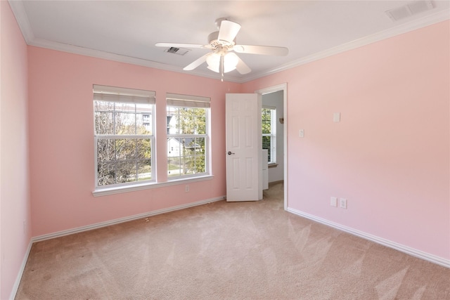 unfurnished room featuring visible vents, baseboards, carpet flooring, and crown molding