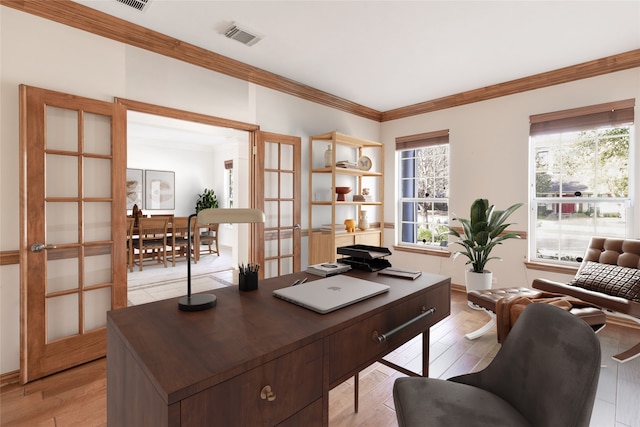 home office with visible vents, light wood-style floors, ornamental molding, and french doors