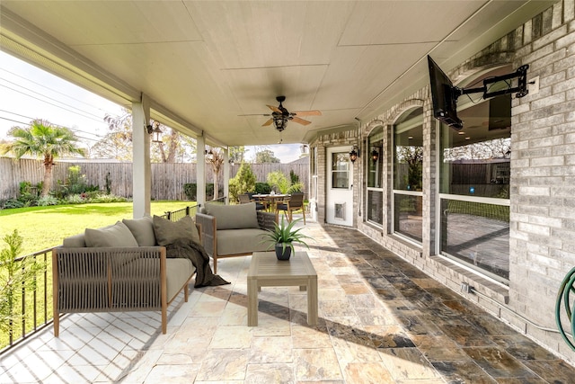 view of patio featuring outdoor lounge area, a fenced backyard, and ceiling fan