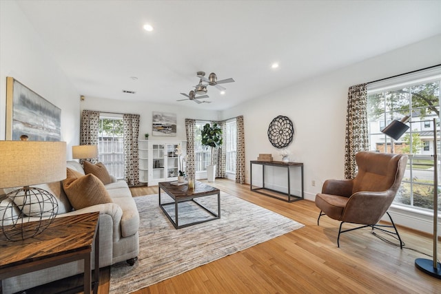 living area featuring recessed lighting, baseboards, wood finished floors, and ceiling fan