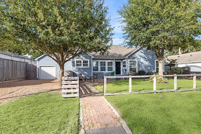 view of front of home with a front yard and fence