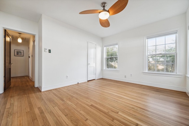 unfurnished room featuring baseboards, ceiling fan, and light wood finished floors