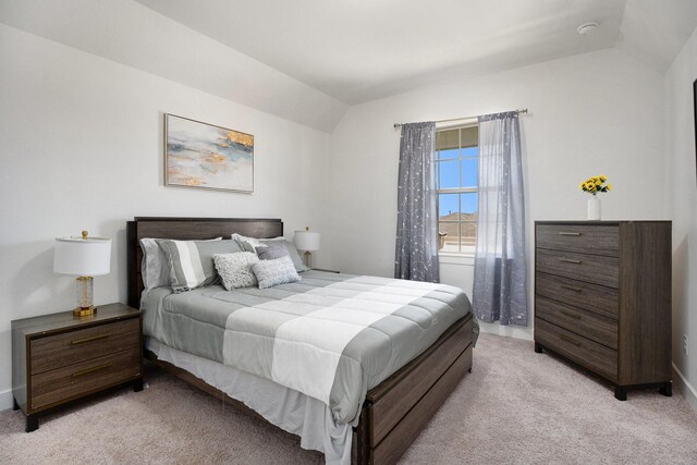 bedroom with light carpet and vaulted ceiling