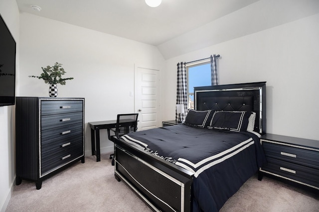 bedroom featuring baseboards, light carpet, and vaulted ceiling