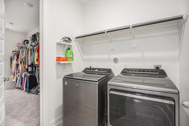 washroom with laundry area, carpet flooring, baseboards, and separate washer and dryer