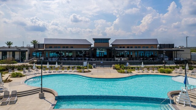 pool featuring a patio and fence