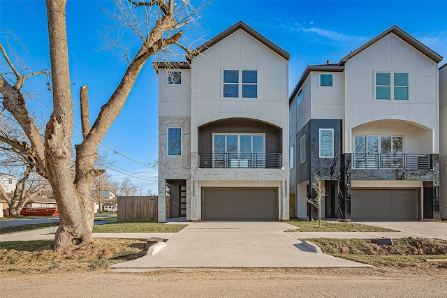 view of front facade with a balcony, a garage, and driveway