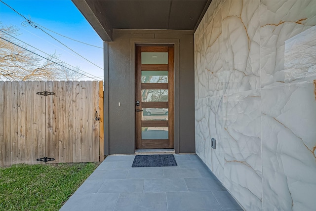 view of exterior entry with fence