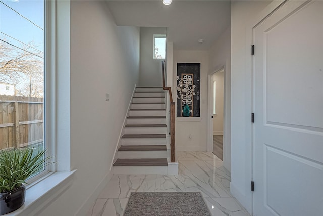 stairs with baseboards and marble finish floor