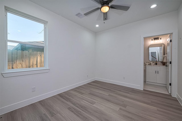 unfurnished bedroom featuring wood finished floors, recessed lighting, baseboards, and visible vents