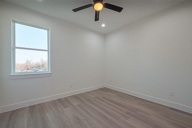 spare room with dark wood-style floors, recessed lighting, a ceiling fan, and baseboards