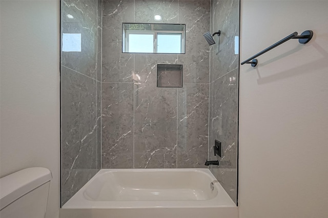 bathroom featuring toilet and shower / bathtub combination