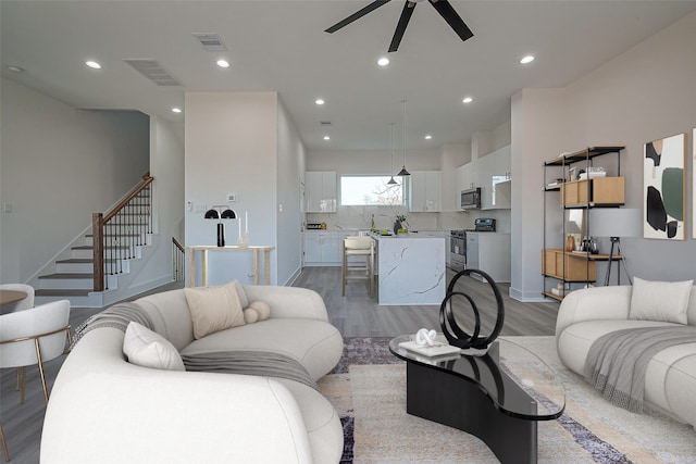 living area featuring visible vents, recessed lighting, and light wood-style floors